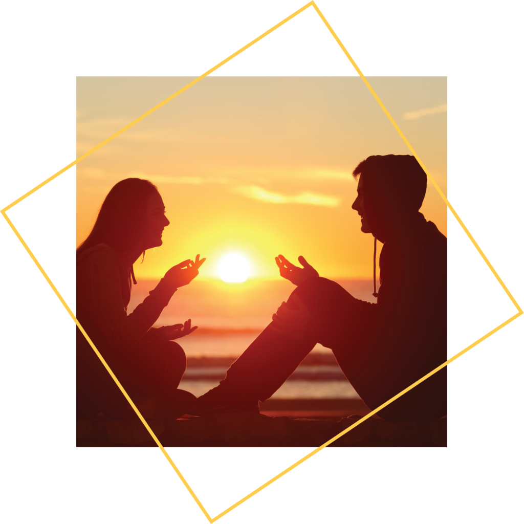 Two people talking at sunset