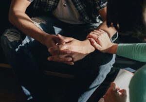 Hands of people in a mental health treatment program