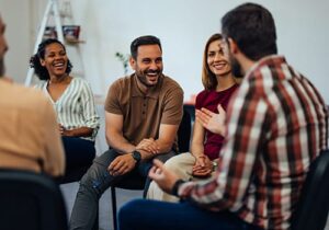 People sitting and socializing in a substance abuse treatment program