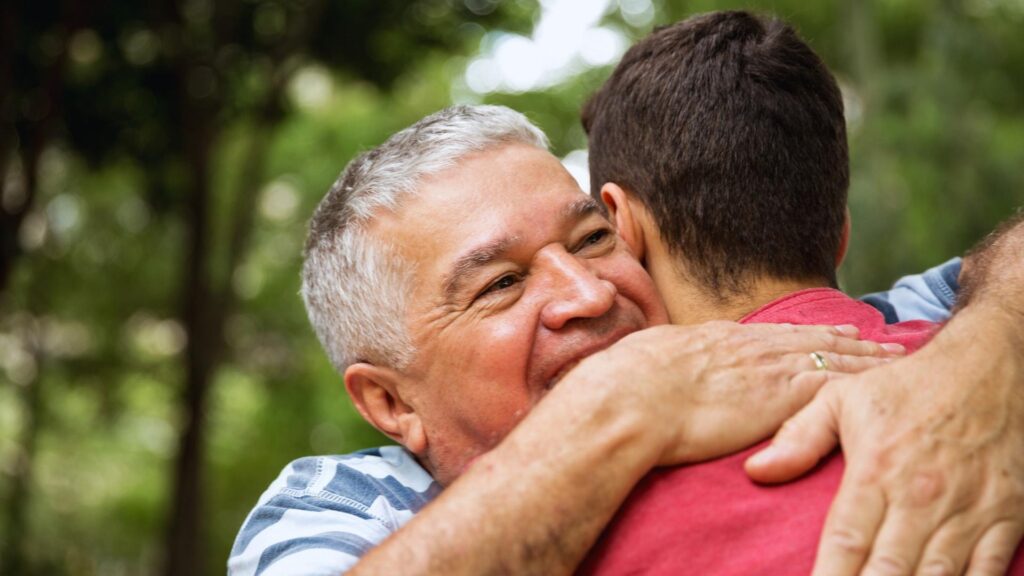 father embraces his son after getting into rehab through medicaid