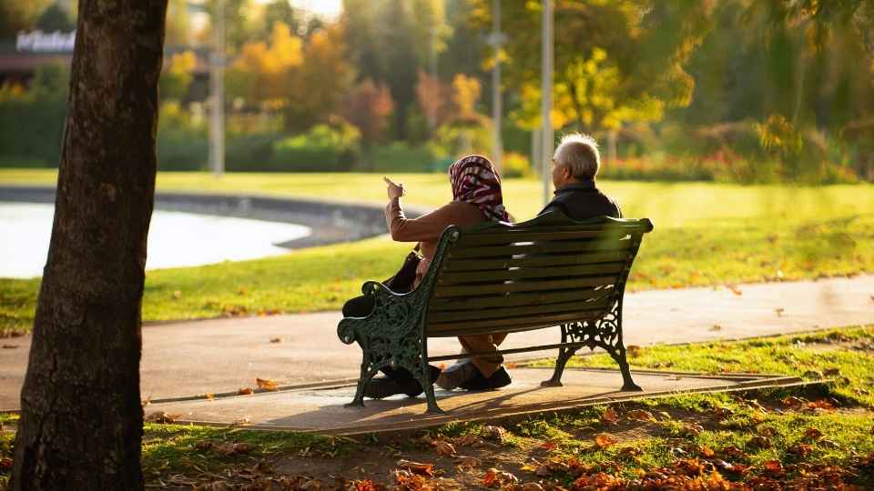 How Long Does Adderall Stay in Your System? an elderly couple sitting on a park bench illustrates how age is a factor in metabolism.