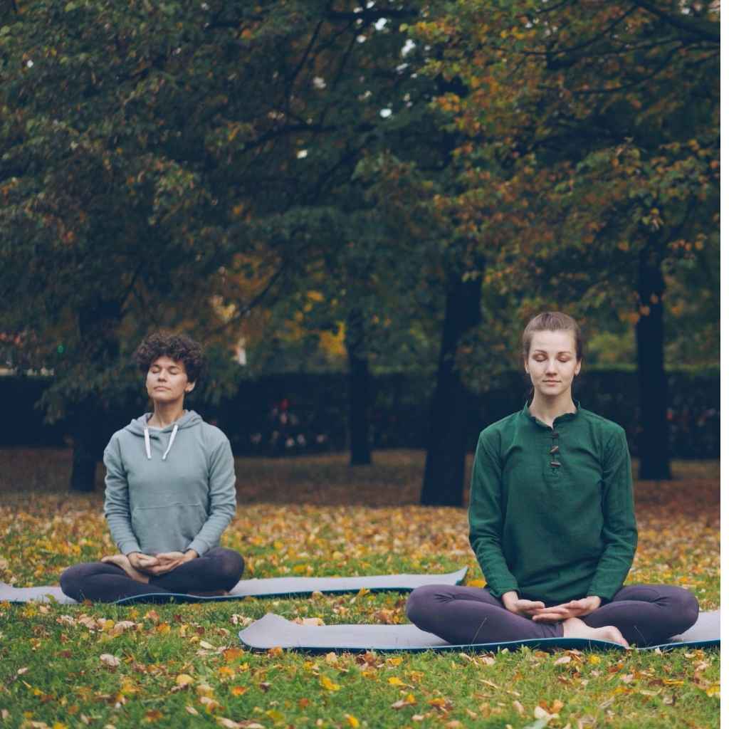 Two women sitting and using yoga as relapse prevention tool