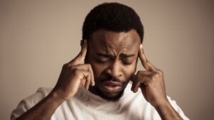 Wet Brain (Wernicke-Korsakoff Syndrome hero image of someone holding their head after the wet damage of the brain.