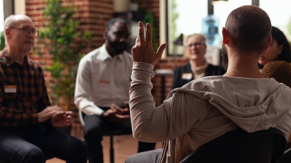 How to Lead an AA Meeting hero image of people in recovery.