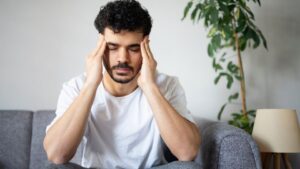 Kratom Side Effects hero image of a man with a headache.